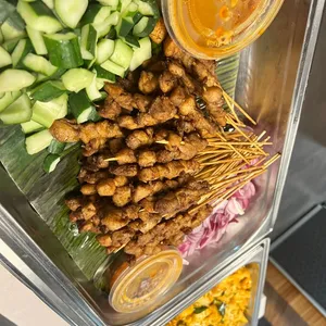 Singapore-styled chicken satay<br> peanut sauce, raw onions, cucumber <br> Contains allium and nuts, Spicy