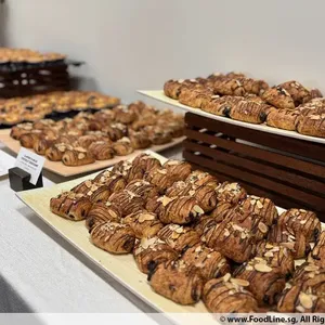 Almond Pain Au Chocolat Croissant <br> a sweet puff pastry filled with dark chocolate <br> Vegetarian, Contains dairy, egg, nuts and wheat