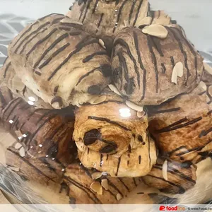 Almond Pain Au Chocolat Croissant <br> a sweet puff pastry filled with dark chocolate <br> Vegetarian, Contains dairy, egg, nuts and wheat