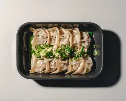 Steamed Plant-based Gyoza (V) <br> poached garlic, spring onion, black sesame seeds, light mala soy dipping<br> vegan, contains allium, wheat and soy | Customer Photo | Grain